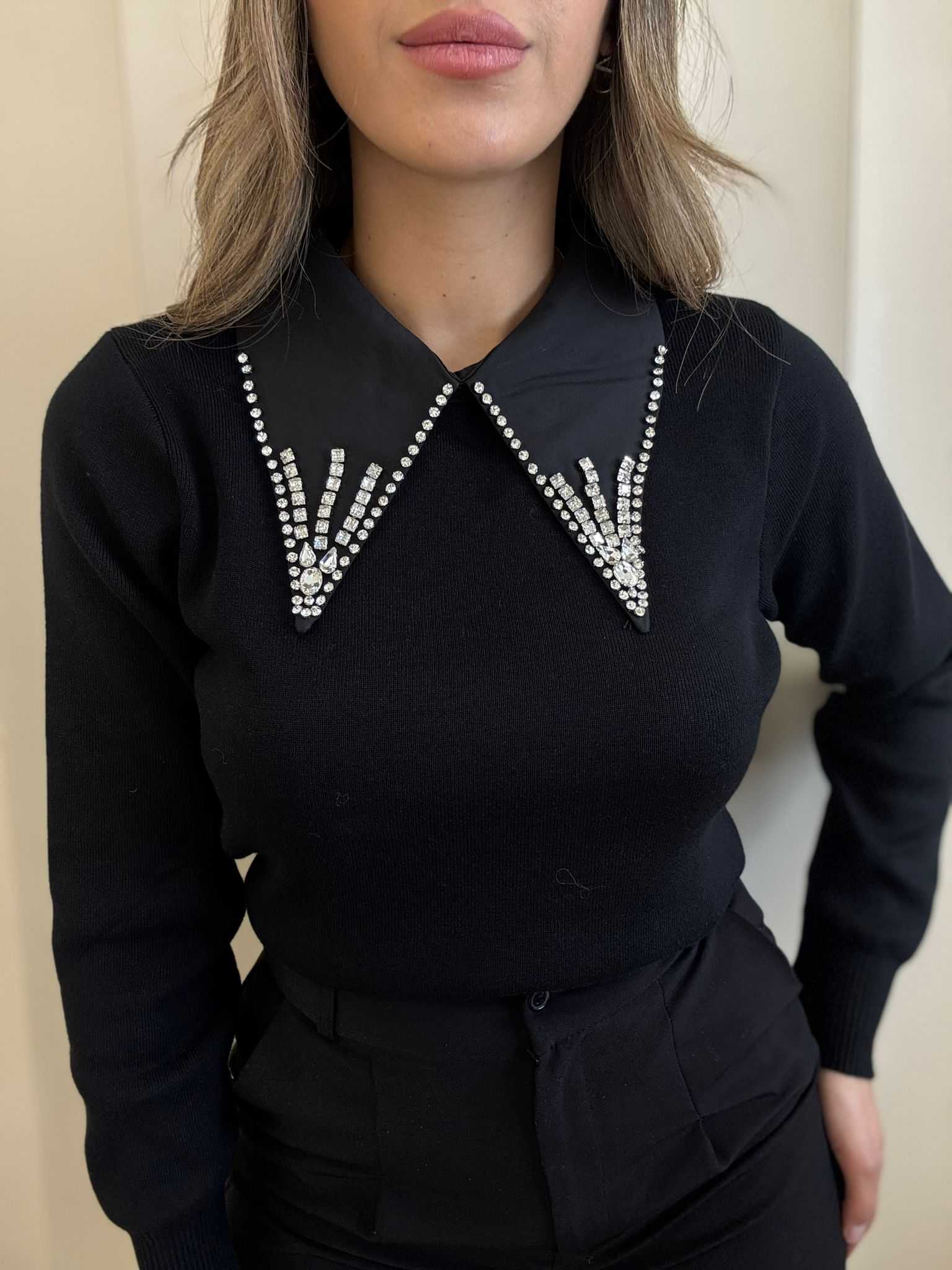 Women’s black long-sleeve top with embellished rhinestone collar detail